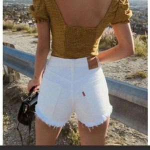Levi’s 501 Mid-Rise white distressed denim shorts